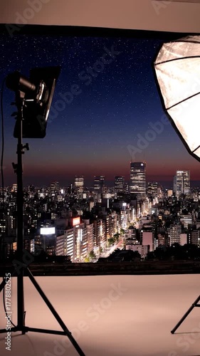 A cityscape silhouetted against a twilight sky, studio lights frame the buildings from a camera perspective
