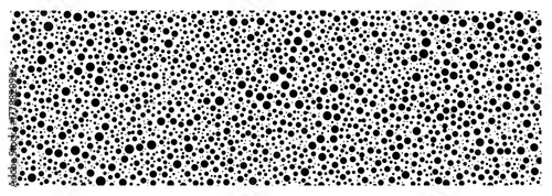 Dense polka dot pattern with random circles seamless black and white vector background