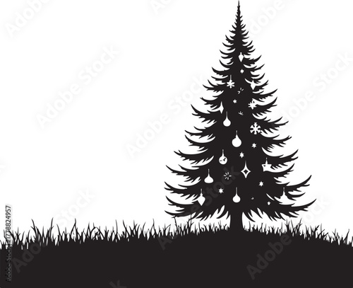 Black silhouette of a decorated Christmas tree on grass