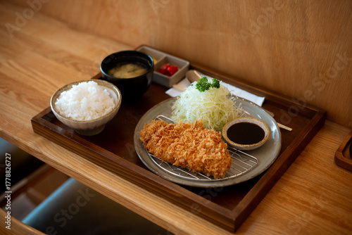 Japanese deep fried pork or Tonkatsu set with rice and miso soup on table.