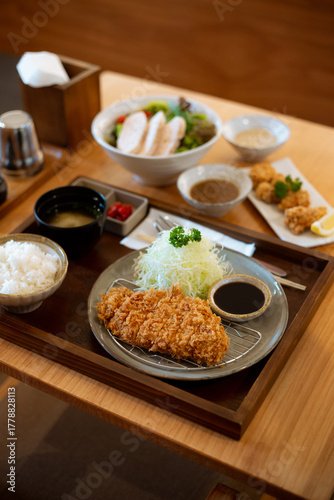 Japanese deep fried pork or Tonkatsu set with rice and miso soup on table.