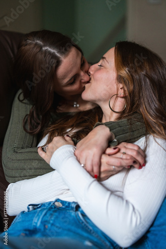 Couple embracing and kissing affectionately at home