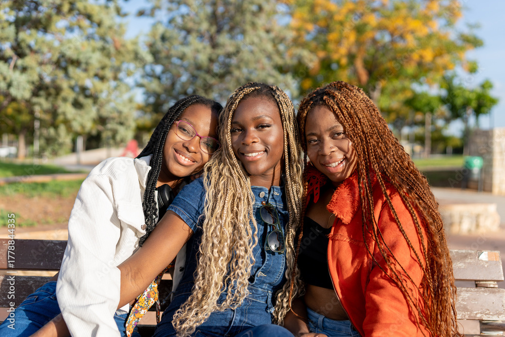 Fototapeta premium Young black women friends smiling enjoying park time