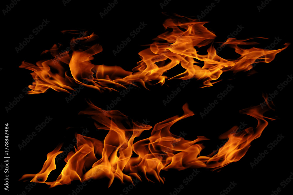Fototapeta premium Blazing fire and glowing flames on a dark background perfect for creative design and visual effects. 