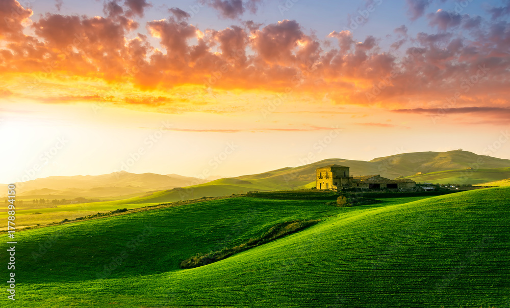 Obraz premium amazing sunset among green spring hills in highland farm with castle , mountains and picturesque colorful sunset on background of landscape