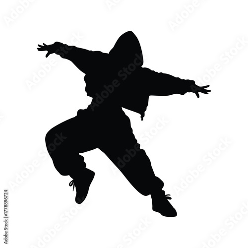 Silhouette of a dynamic hip hop dancer in a hooded jacket and loose pants mid motion