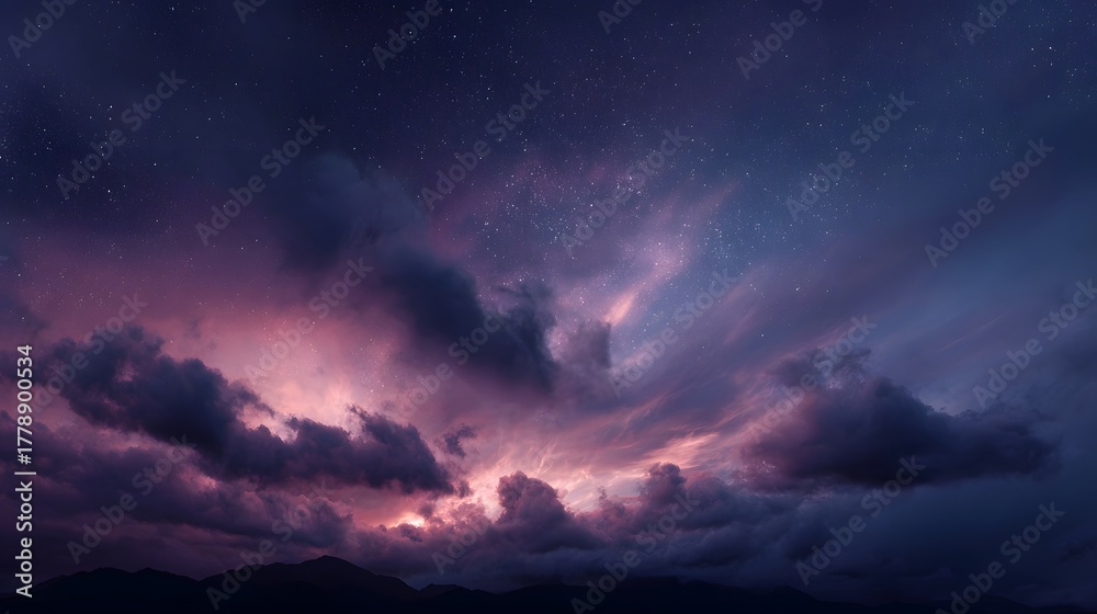 Fototapeta premium A dramatic twilight sky with colorful clouds and stars over mountain silhouettes