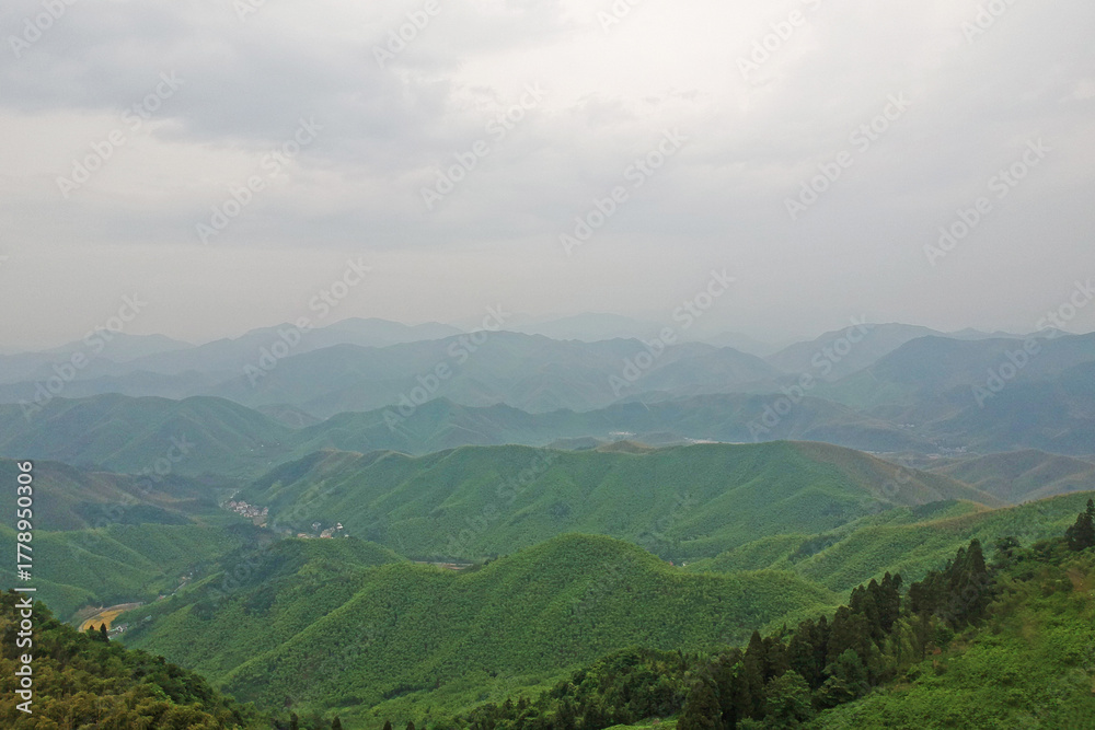 Fototapeta premium Aerial View of Moganshan Scenic Area Surrounded by Green Mountains