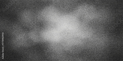 Abstract textured background with a bright center and dark grainy edges in grayscale