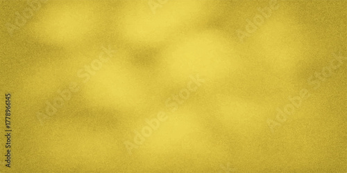 Abstract golden yellow textured background with soft blurry light and shadow patterns