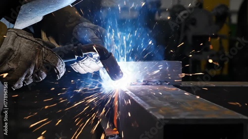 Metal fabrication process showing intense arc light and flying sparks during joint connection