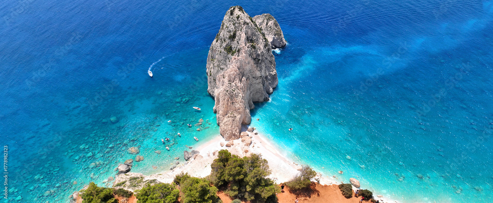 Fototapeta premium Aerial drone ultra wide panoramic photo of scenic small islet of Mizithres in Keri area forming double turquoise sandy beaches a true paradise for small boats, Zakinthos island, Ionian, Greece