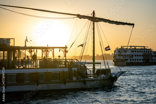 Quadro em tela Traditional felucca sailing at sunset on the Nile, Kom Ombo, Egypt