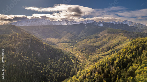 Fototapeta Naklejka Na Ścianę i Meble -  Sunlit aerial view of autumn mountain forest and valley, Tatra Mountains, Poland