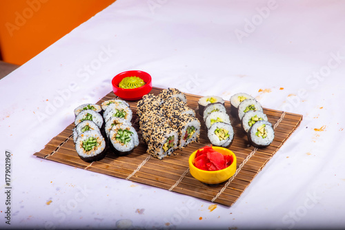 Delicious Japanese sushi set with nigiri, maki rolls, and soy sauce served on a wooden board. Traditional Asian cuisine concept.