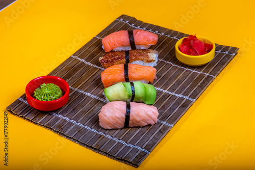Delicious Japanese sushi set with nigiri, maki rolls, and soy sauce served on a wooden board. Traditional Asian cuisine concept.