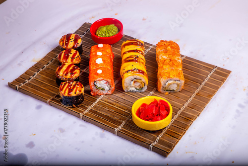 Delicious Japanese sushi set with nigiri, maki rolls, and soy sauce served on a wooden board. Traditional Asian cuisine concept.