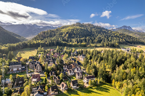 Fototapeta Naklejka Na Ścianę i Meble -  Cozy Village in Polish Mountains, Aerial View and Forested Hills