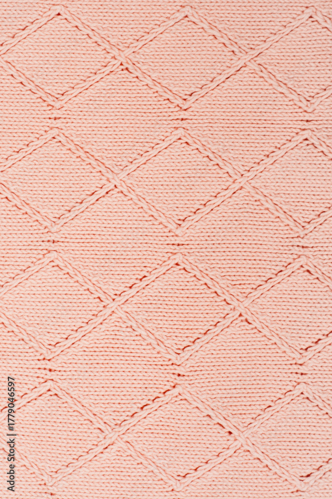 Fototapeta premium Sweater or scarf fabric texture large knitting. Knitted jersey background with a relief pattern. Wool hand- machine, handmade.