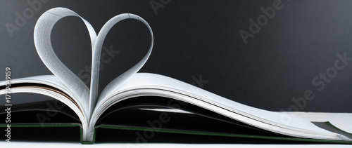 Old open hardback book, page decorate into a heart shape for love in Valentine's. love with open book heart.