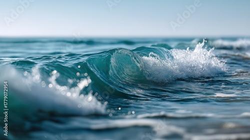 Fototapeta Naklejka Na Ścianę i Meble -  Beautiful ocean wave crashing over the water with vibrant blue colors showcasing natural seaside landscape scenic outdoor view and peaceful marine environment