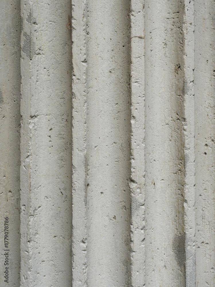 Fototapeta premium Fluted stone column with weathered surface classical architecture and structure. Copyspace.