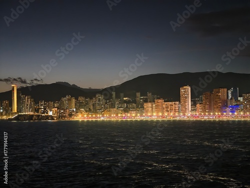 Photography tranquil seaside panorama during twilight featuring illuminated waterfront and d