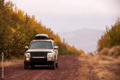 Japanese SUV on scenic autumn road in the forest