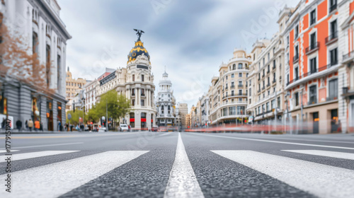 Gran Via street in Madrid downtown, reflecting urban life with light trails from moving vehicles and historic architecture
