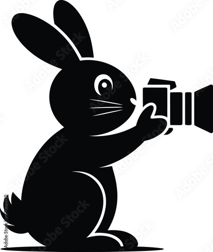 A black silhouette of a rabbit holding and operating a camera