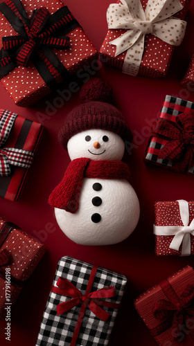 Snowman beside bright present boxes and decorative ribbons.