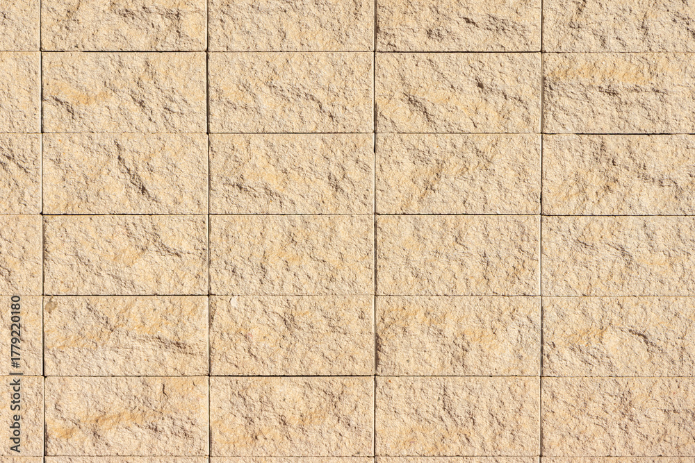 Obraz premium Beige stone wall building exterior texture background