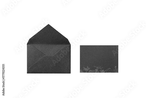Overhead shot of a black card with a line-drawn flower illustration, placed next to the opened back side of a black envelope