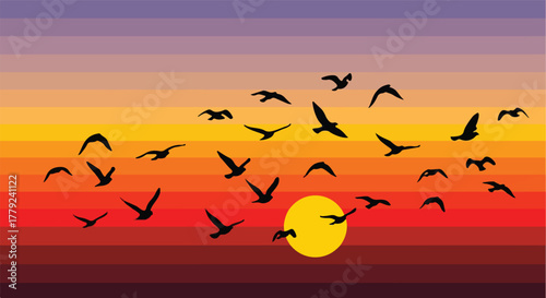 Birds silhouetted against a sunset sky