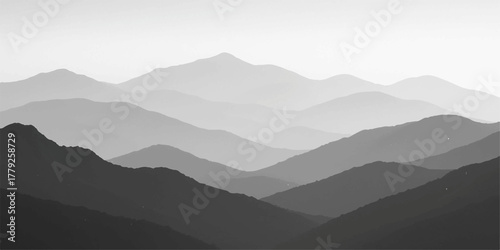 Misty mountain landscape with fog rolling over the hills at sunrise