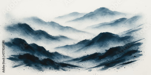 Snowy mountain peaks touch the blue sky at sunrise, showcasing a beautiful winter landscape with clouds and mist filling the valley