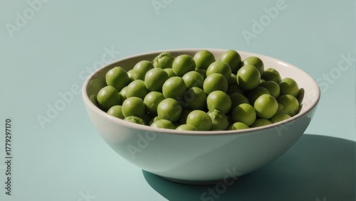 Bowl of Fresh Green Peas on Light Blue Background.