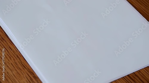 Blank white paper or document on a wooden surface