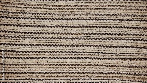 Textured woven fabric with horizontal stripes of light beige and dark brown