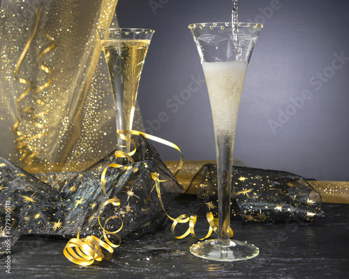 New Year concept, with bright light and champagne glass, abstract bokeh background