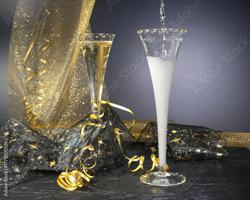 New Year concept, with bright light and champagne glass, abstract bokeh background