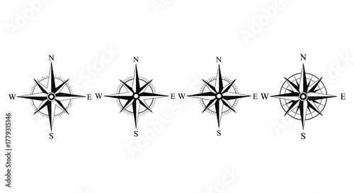 Four compasses showing different orientations isolated on white background
