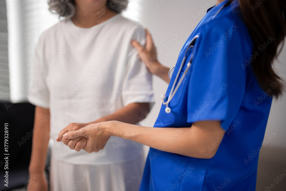 Obraz premium Asian Adult Nurse Tenderly Supports Older Adult Woman Hands Holding Compassionate Healthcare Home Assistance