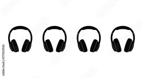 Four headphones are arranged in a row isolated on white background