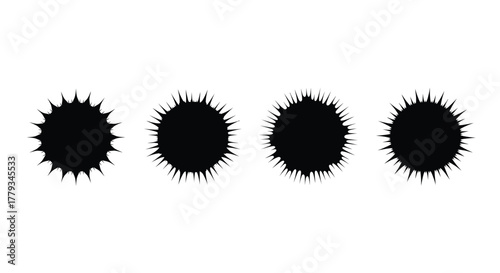 Four black ink blots isolated on white background in a row