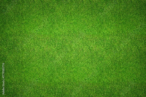 Green grass field background top view texture - aerial of a large patch of some freshly cut, healthy, green grass lawn for sports pitch.