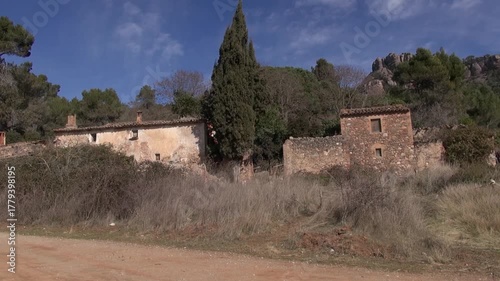 Can Robert road dirt path stone old facade front La Mola pan