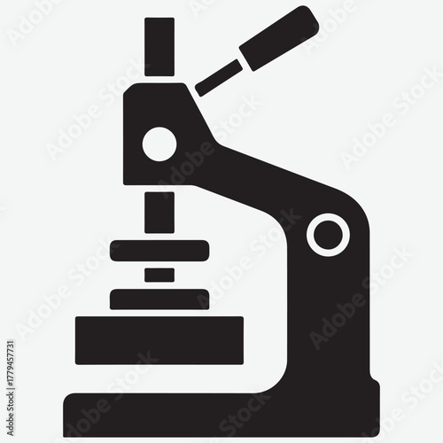 Black Silhouette Icon of a Button Making Machine