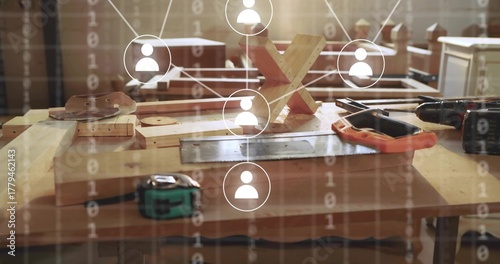 Showing bench featuring drill tape measure and X-puzzle at carpentry workshop, with network overlay