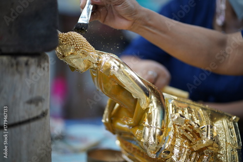 Thai Traditional Art: Gilding a Buddha Statue with Gold Leaf